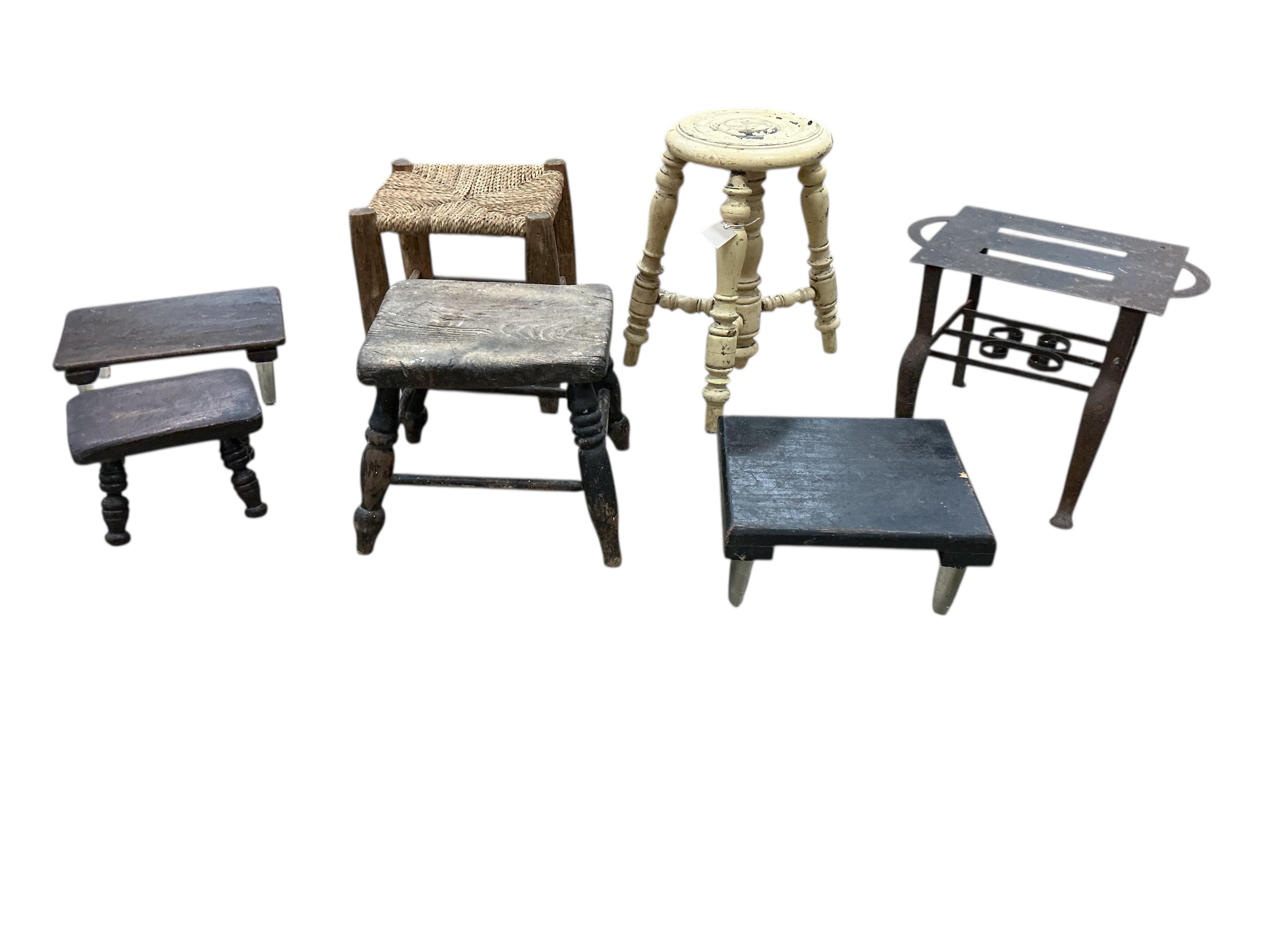 Four 19th century Provincial stools, together with two glass legged stands and an iron trivet
